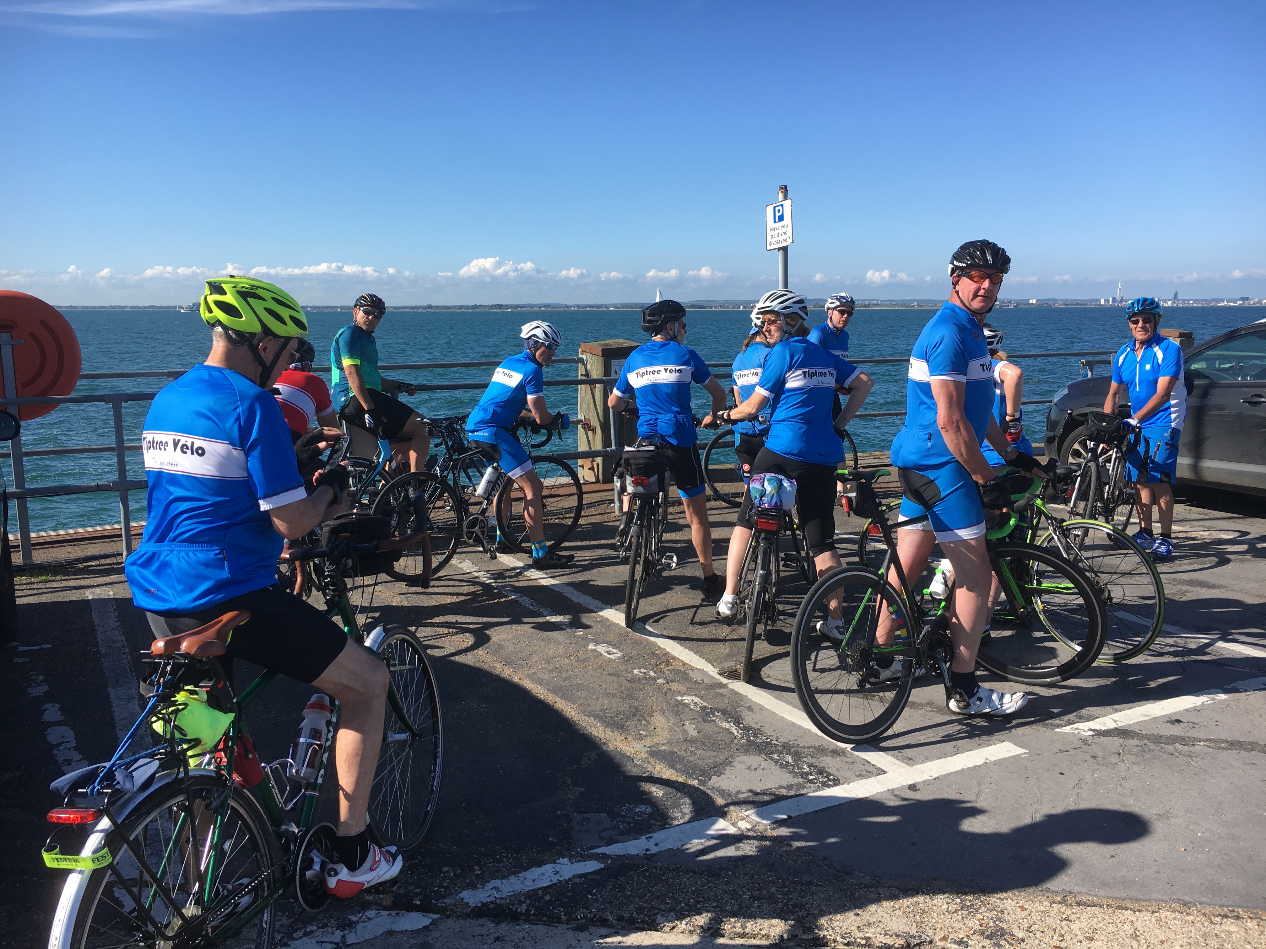 A group of cyclists from Tiptree Velo looking out over the water.